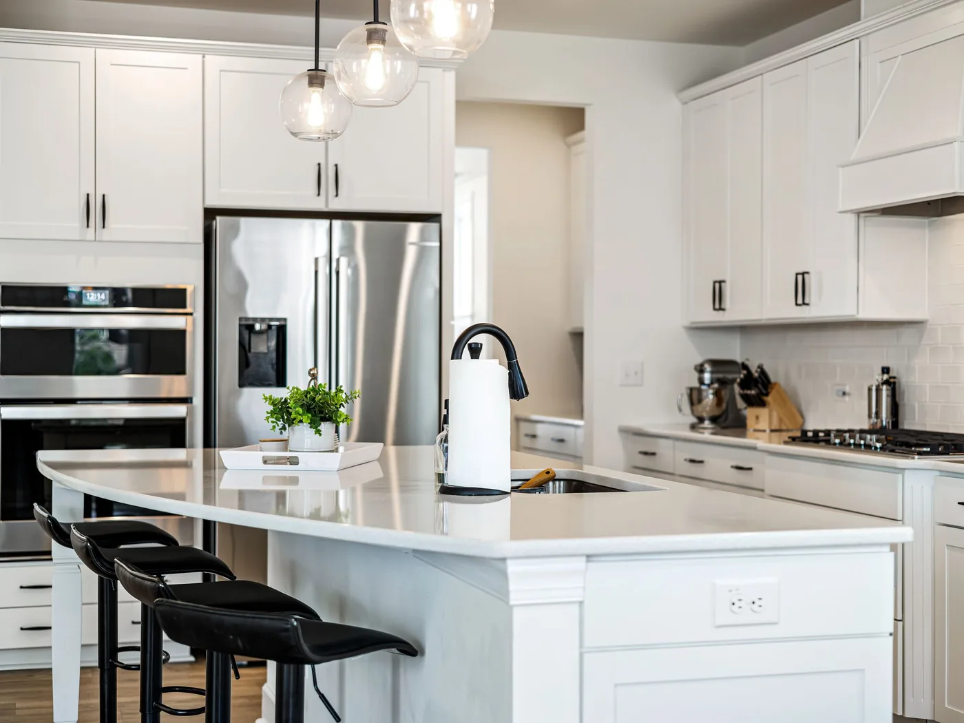 Clean white kitchen island representing recurring home cleaning